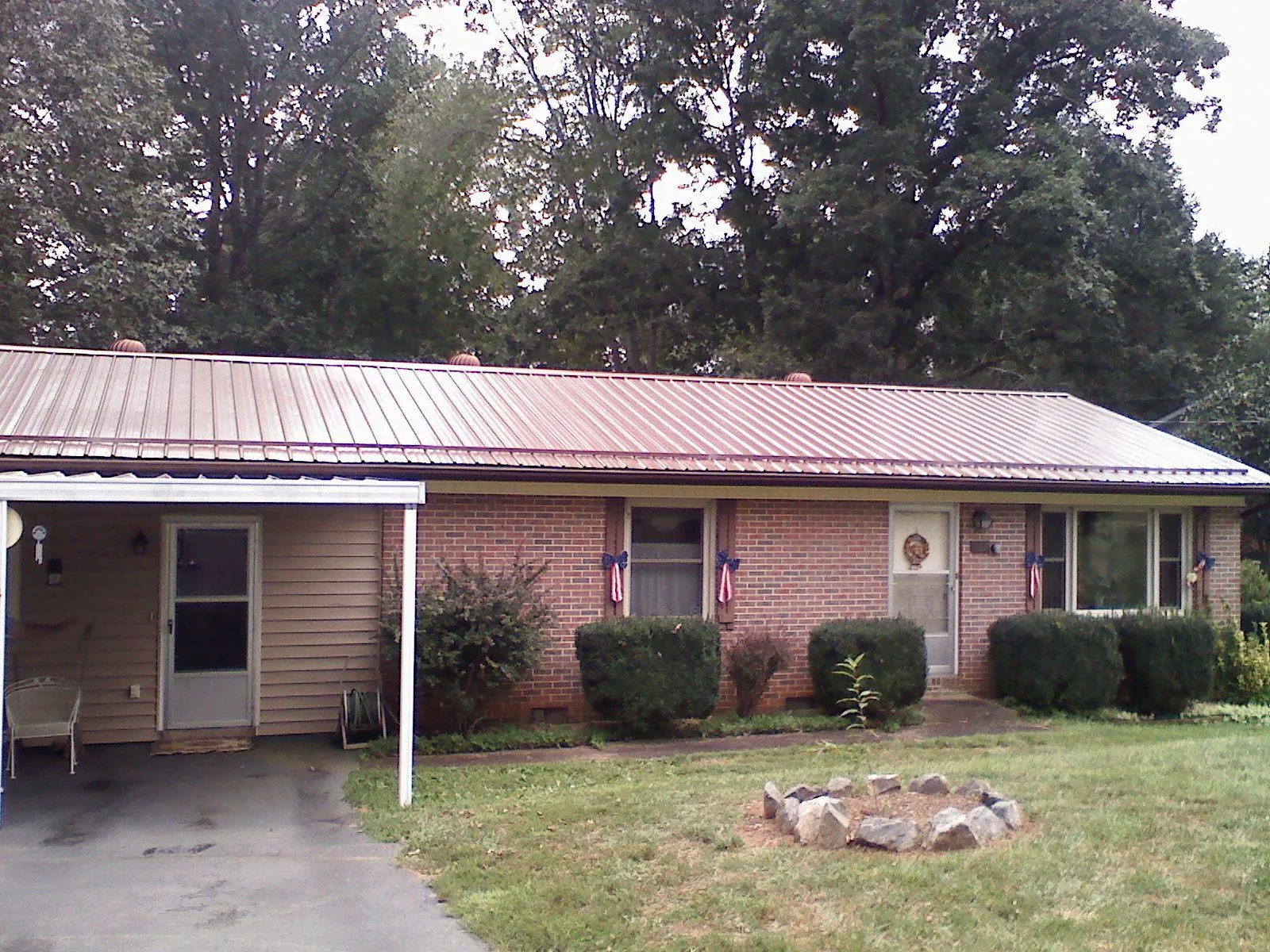 Bronze metal roof and carport on a brick ranch home — Roof Repair work by our crew in Oregon City